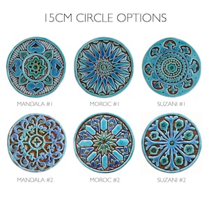 May include: Six 15cm ceramic tiles with different geometric patterns in shades of blue, green, and brown. The tiles are arranged in two rows of three, with the names "Mandala #1", "Moroc #1", "Suzani #1", "Mandala #2", "Moroc #2", and "Suzani #2" printed below each tile.