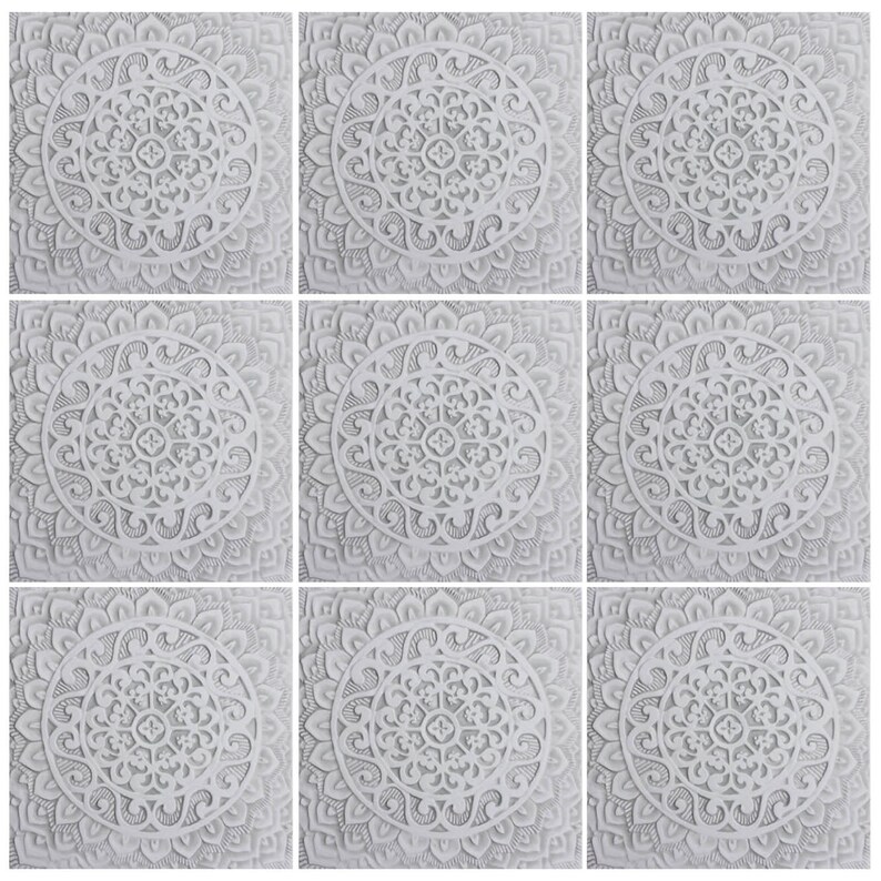 May include: Nine white square tiles with intricate, symmetrical, mandala-like designs. Each tile features a circular pattern with a central motif and radiating lines.