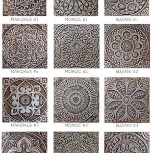 May include: A set of 12 decorative tiles featuring intricate patterns inspired by Moroccan, Mandala, and Suzani designs. The tiles are made of a textured material with a silver-grey color.