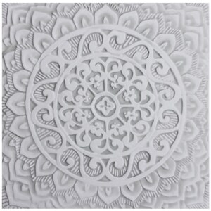May include: White ceramic wall decor with a raised, intricate mandala design. The mandala features a circular pattern with multiple layers of floral and geometric shapes.