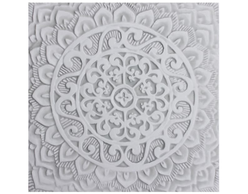 May include: White ceramic wall decor with a raised, intricate mandala design. The mandala features a circular pattern with multiple layers of floral and geometric shapes.