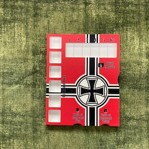 May include: A rectangular red game board featuring a black and white cross emblem in the center. The board includes white square cutouts for dice, a numbered track from 1 to 6+, and text labels reading Command Dice, Force Morale, and Chain of Command.
