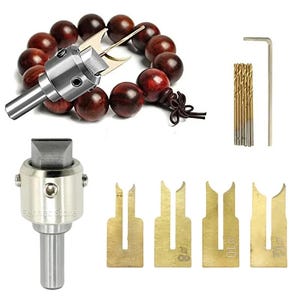 May include: A collection of woodworking tools, including a silver metal tenon cutter, drill bits, and a set of brass tenon gauges. A strand of dark red wooden beads is also present.