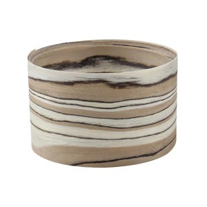 May include: A cylindrical roll of thin, flexible wood veneer featuring a natural grain pattern with alternating horizontal bands of light beige, cream, and dark brown tones. The surface displays organic, flowing lines and wood texture.