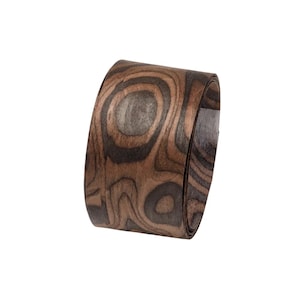 May include: A curved wooden band with a distinctive wood grain pattern. The band displays shades of brown and black, creating a natural, organic aesthetic. The wood grain design is visible across the surface.
