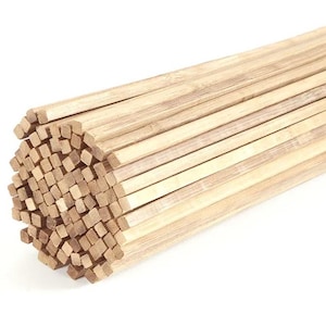 May include: A bundle of light brown wooden dowels, tightly packed together. The dowels are rectangular in shape and appear to be made of bamboo or a similar wood. The ends of the dowels are visible, creating a textured surface.