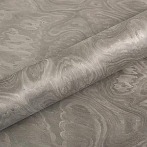 May include: A roll of gray marbled paper with a swirling pattern. The paper has a smooth, glossy finish and a subtle variation in tone, creating a sense of depth and texture. The paper is partially unrolled, revealing the pattern.