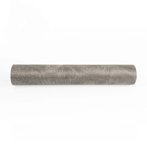 May include: A cylindrical object with a wood grain pattern in shades of gray. The object is a roll of wallpaper or decorative paper, likely for home decor projects. The surface has a swirling, naturalistic design.