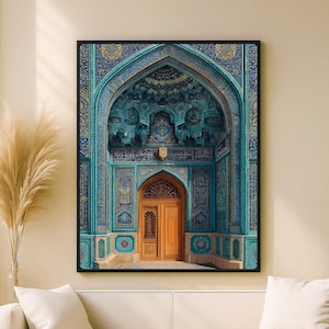 May include: A framed print of an ornate archway and door. The archway is a vibrant teal color with intricate patterns and designs. The door is a warm orange-brown color. The print is displayed on a beige wall.