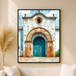 May include: Watercolor painting of a church facade with a teal door and arched entryway. The building has a white exterior with aged texture, a stone arch, and a small circular window. The artwork is framed in black.