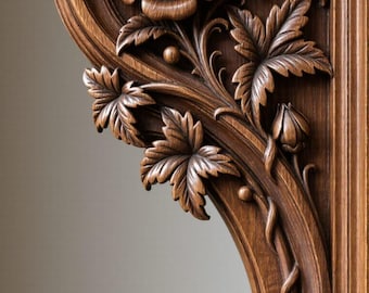 May include: Detailed wood carving featuring a rose and foliage. The dark brown carving has a curved shape with a rose at the top, leaves, and a spiraling design at the bottom. The wood grain is visible.
