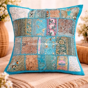 May include: A square patchwork pillow with a turquoise border and a variety of patterned fabric squares in shades of blue, gold, and pink. The pillow has the text "Beautiful Turquoise Patchwork Pillow" and "Triveni Handicrafts".