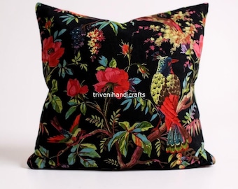 May include: Square black pillow with a vibrant floral and bird pattern. The design features red roses, colorful birds, and green foliage against a black background. The text "trivenihandicrafts" is visible on the pillow.