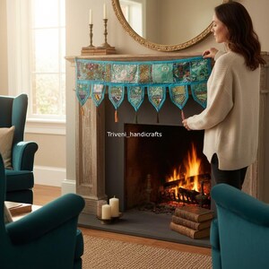May include: A decorative fireplace mantel scarf with a patchwork design in shades of teal, green, and gold. The scarf has a teal border and decorative tassels. The text "Triveni_handicrafts" is visible on the mantel.
