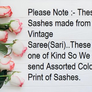 May include: Image features pink and white roses with green stems and leaves, arranged on a white wooden surface. Text reads: "Please Note: These Sashes made from Indian Vintage Saree(Sari)..." The image suggests a product made from vintage Indian sarees.