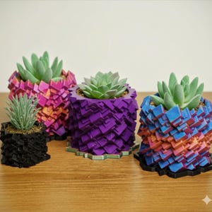 May include: Four geometric planters in various colors, each holding a succulent plant. The planters are black, purple, pink, and blue, with a textured, angular design. The succulents are green and add a natural element to the modern aesthetic.