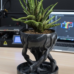 May include: A set of three ceramic mugs with a speckled, matte finish. The mugs are in shades of cream, light gray, and dark gray. Each mug has a simple, minimalist design, perfect for coffee or tea.