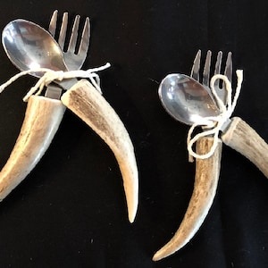 May include: Two sets of antler handled silverware. Each set includes a fork and spoon tied together with twine.