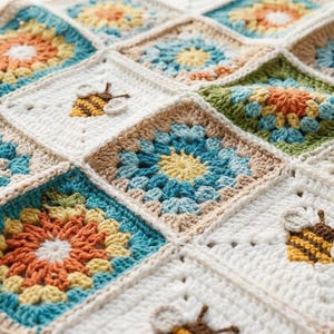 May include: A handmade crochet blanket featuring a patchwork design with square motifs. The squares display floral patterns in shades of orange, blue, and green, with a cream-colored background. Some squares have bee appliqués.
