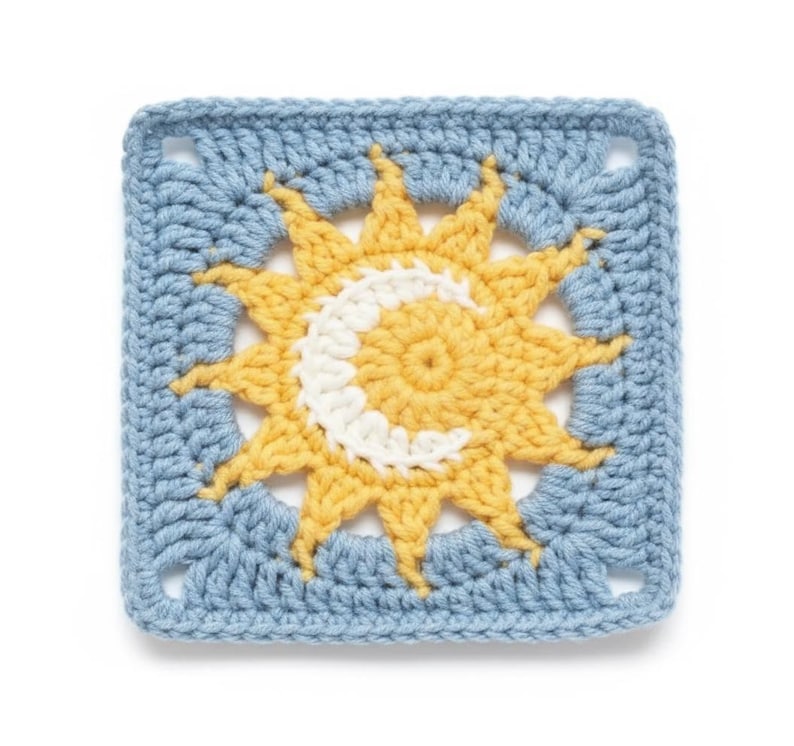 May include: A square, crocheted piece featuring a sun and moon design. The sun is yellow with white accents, and the moon is white. The background is a light blue, and the piece is likely part of a larger craft project.