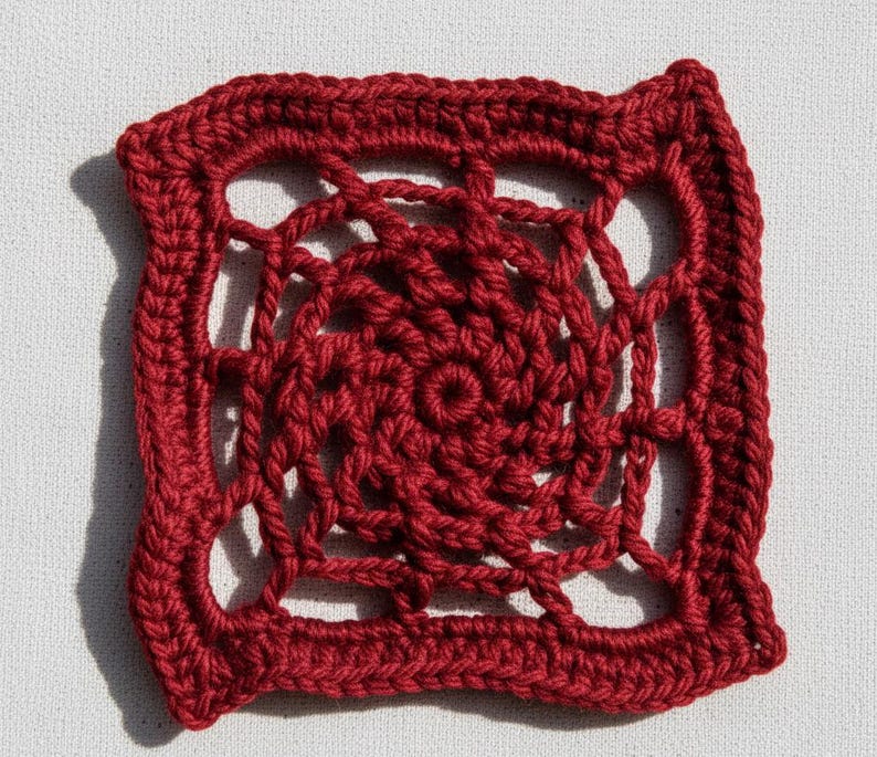 May include: A square, openwork crochet doily in a deep red hue. The design features a central spiral pattern surrounded by an open, geometric border. The handmade piece is displayed on a white surface.