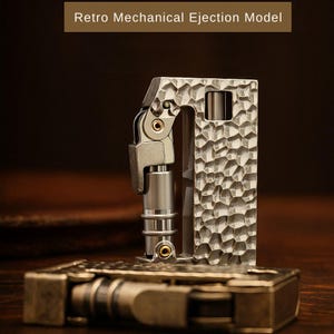 Op de afbeelding: Een retro mechanisch uitwerpmodel, met een getextureerde, zilverkleurige behuizing en een scharniermechanisme. Het ontwerp omvat een rechthoekig frame met een gehamerd metalen uiterlijk en de tekst "Retro Mechanical Ejection Model".