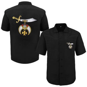 May include: Black short-sleeved button-down shirt with a small pocket on the chest. The shirt features an embroidered emblem of a sword, crescent, and cross in gold, silver, and black. The back of the shirt has a larger version of the emblem.