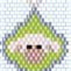 May include: A green and white felt ornament shaped like a baby with a pink nose and brown eyes.