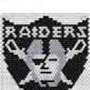 以下が含まれることがあります： ラスベガス・レイダースのロゴの白黒ピクセルアートデザイン。ロゴは、交差した剣を持つ頭蓋骨と、頭蓋骨の上に「RAIDERS」という文字が書かれています。