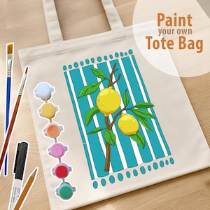 May include: A cream-colored canvas tote bag featuring a printed design of two yellow lemons on a brown branch against a background of vertical teal and white stripes. The text Paint your own Tote Bag is printed in brown. Includes paint pots and brushes.