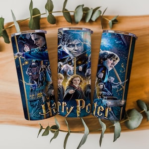 May include: Three cylindrical tumblers featuring a wrap-around graphic print of Harry Potter characters, including Harry, Hermione, and Ron, with the golden Harry Potter logo text at the bottom. The design includes dark blue and gold tones.