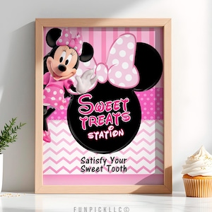 May include: A framed print featuring Minnie Mouse and the words "Sweet Treats Station." The design includes a pink and white polka dot bow, a pink and white striped background, and the phrase "Satisfy Your Sweet Tooth."