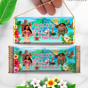 a hand holding a birthday candy wrapper with a cartoon character on it
