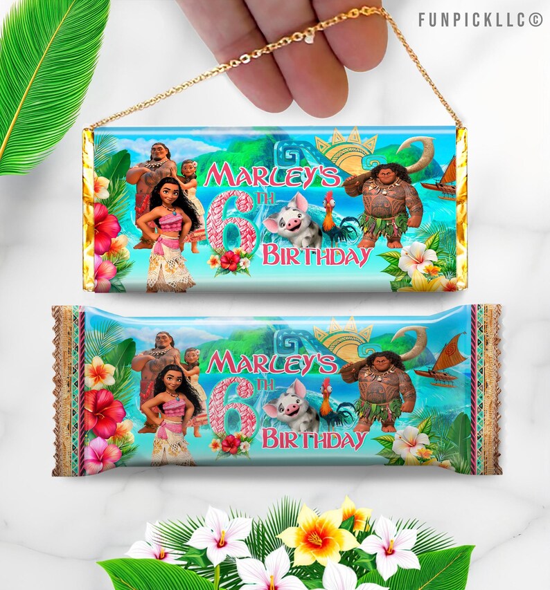 a hand holding a birthday candy wrapper with a cartoon character on it