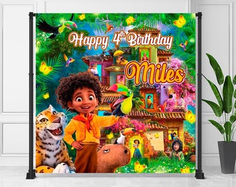 May include: A colorful birthday backdrop featuring a cartoon character with a tiger, toucan, and capybara. The backdrop has the text "Happy 4th Birthday Miles" with a vibrant house and floral design, and butterflies.