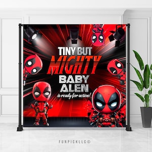 May include: A red and black backdrop with the text "TINY BUT MIGHTY BABY ALEN is ready for action!" and Deadpool cartoon characters. The backdrop is supported by a black metal frame. The Funpick LLC logo is at the bottom.