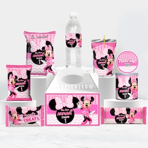 May include: A collection of pink and black Minnie Mouse-themed party supplies. The set includes treat bags, a water bottle, a juice box, a chip can, and a gift box, all featuring Minnie Mouse graphics and the text "Armani Turns 1."