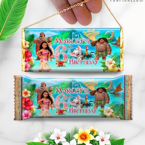 May include: Two chocolate bar wrappers with a gold chain. The wrappers feature characters from the movie Moana, with the text "Marley's 6th Birthday". The design includes flowers and tropical imagery.