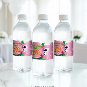 three bottles of water sitting on top of a table