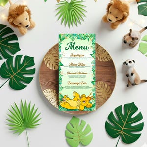 May include: A decorative menu with a jungle theme, featuring the word "Menu" at the top. The menu is surrounded by plush lion toys, green paper leaves, and a wooden plate. The menu includes sections for Appetizers, Main Bites, Dessert Station, and Beverage Bar.