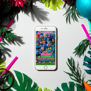 a smartphone displaying a colorful and vibrant movie poster for "Shara is Turning 3" surrounded by tropical leaves, flowers, and other decorative elements.
