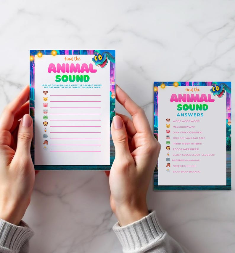 A person's hands holding two colorful cards with blank spaces for answers to a "Find the Animal Sound" game.