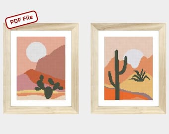 May include: Two framed cross-stitch patterns depicting desert landscapes. The first pattern features a cactus with a sunset background. The second pattern features a mountain range with a cactus in the foreground.