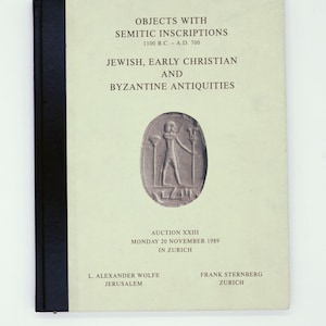 May include: A book cover with the title "OBJECTS WITH SEMITIC INSCRIPTIONS" and the subtitle "JEWISH, EARLY CHRISTIAN AND BYZANTINE ANTIQUITIES." The cover features an illustration of a figure with a staff. The auction details are also included.