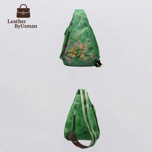 May include: Green leather sling bag with a floral embroidery design. The bag features a zipper closure and brown accents. The bag has the text "Leather ByUsman" and a logo of a handbag.