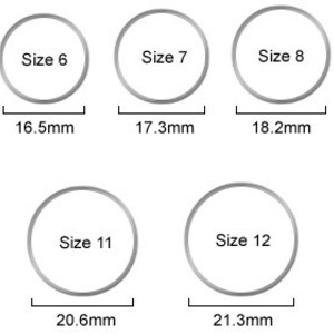 May include: A chart showing ring sizes 5 through 13 with corresponding measurements in millimeters. The chart shows the size of the ring in the center of each circle and the measurement in millimeters below each circle.