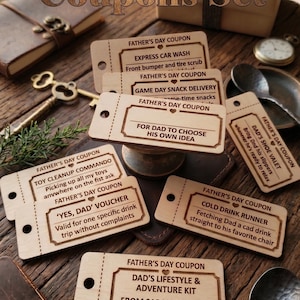 May include: A set of light-colored wooden Father's Day coupons with dark brown laser-engraved text and borders. Each rectangular coupon features a perforated line and a hole punch on the left side, with various activity descriptions printed on them.