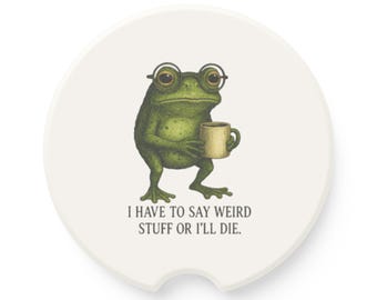 May include: White car coaster with a green frog wearing glasses and holding a mug. The coaster has the text "I HAVE TO SAY WEIRD STUFF OR I'LL DIE."