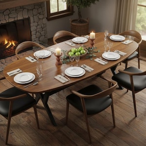May include: An oval wooden dining table set for a meal, surrounded by six chairs with black seats and wooden frames. The table is set with white plates, cutlery, and candles. A fireplace is in the background.