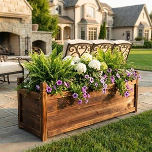 Solid pine garden planter filled with soil and small plants outdoors